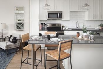 Open kitchen with breakfast bar and pendant lighting